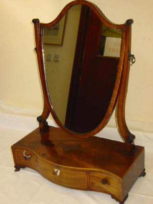 Appraisal: A GEORGE III MAHOGANY TOILET MIRROR of serpentine oblong form