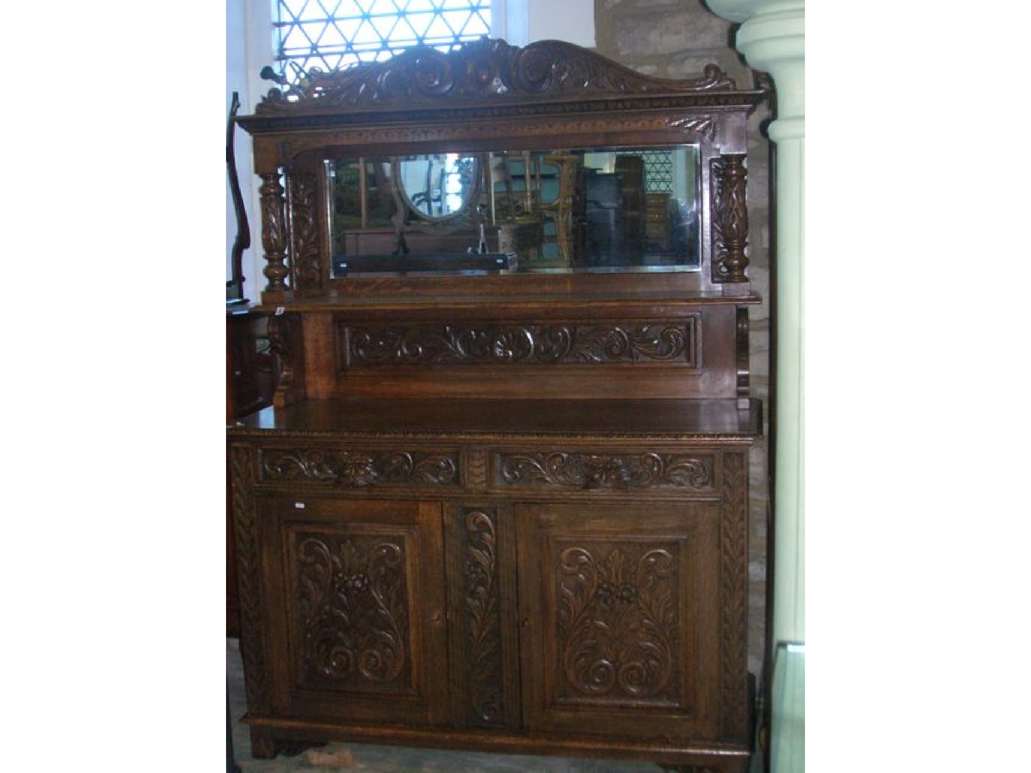 Appraisal: A Victorian oak mirror back sideboard the base enclosed by