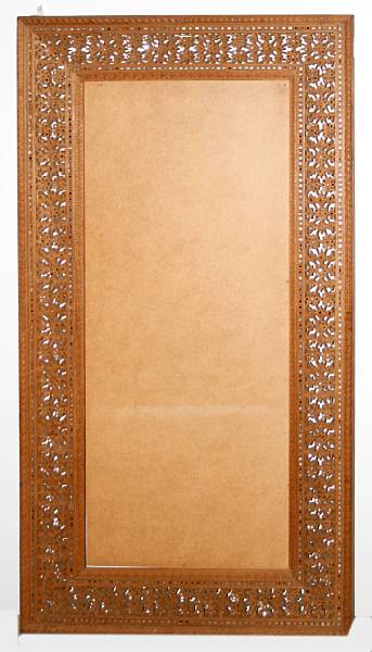 Appraisal: An Indian carvedand reticulated wood mirror frame The vegetal decoration