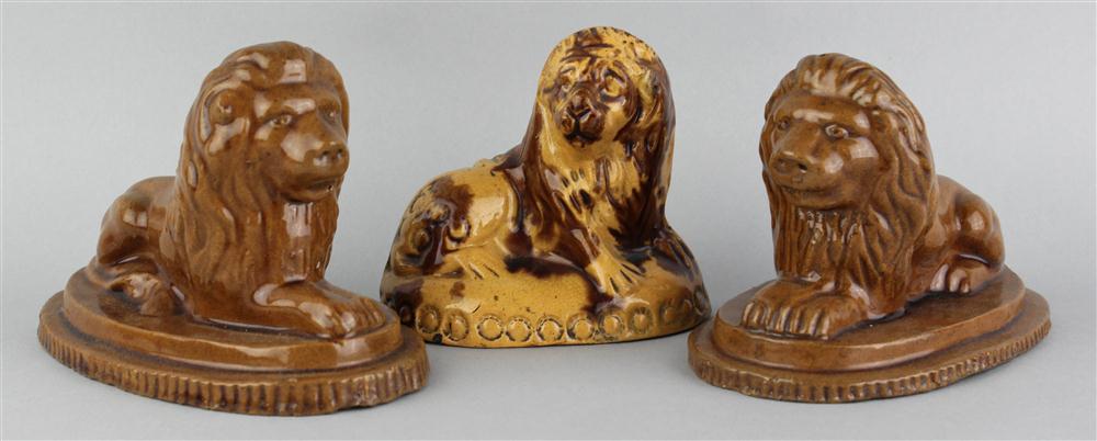 Appraisal: TWO GLAZED REDWARE MODELS OF LIONS th C recumbent on