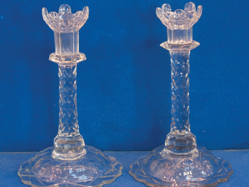 Appraisal: A PAIR OF REGENCY STYLE CUT-GLASS CANDLESTICKS with shaped sconces