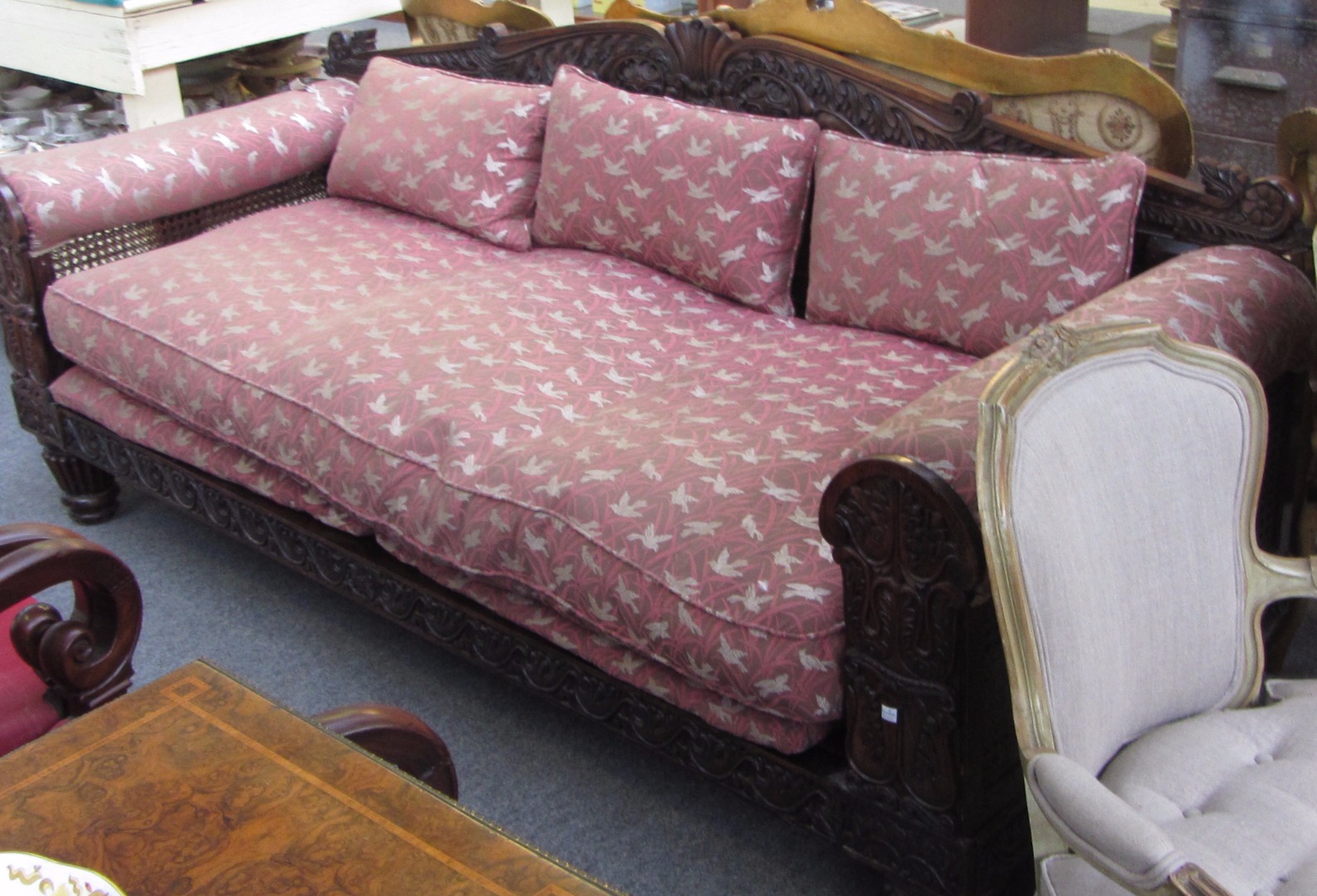 Appraisal: A th century teak framed sofa with double bergere arms