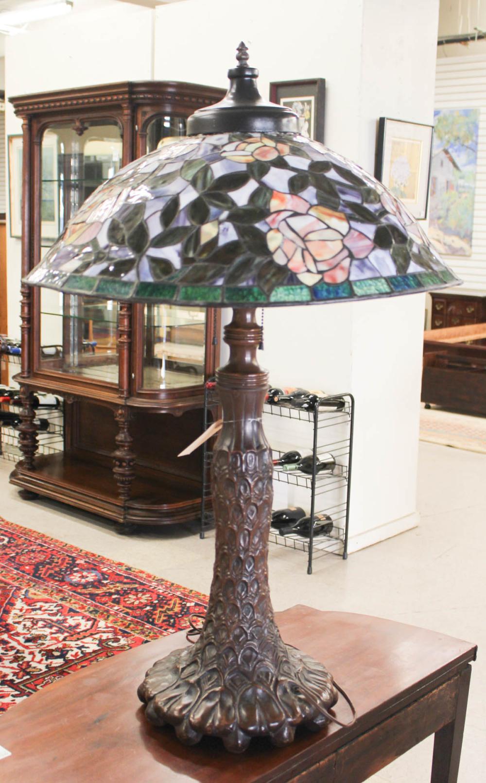 Appraisal: TIFFANY INSPIRED BRONZE AND STAINED GLASS TABLE LAMP late th