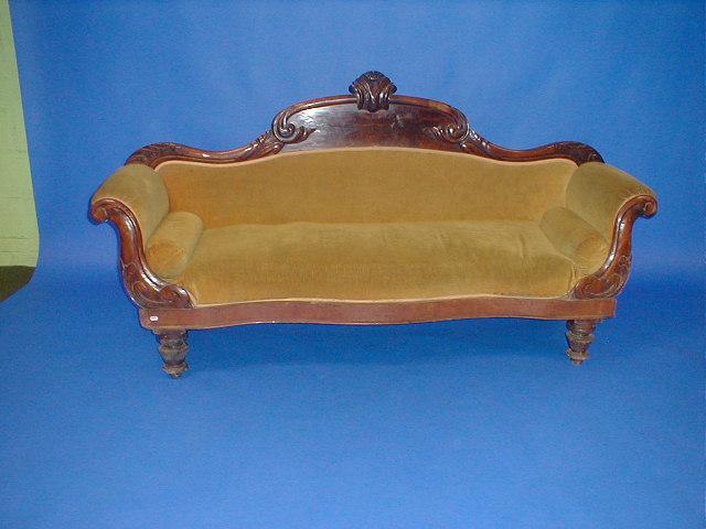 Appraisal: A Victorian mahogany sofa with flamed panelled scrolling back scroll