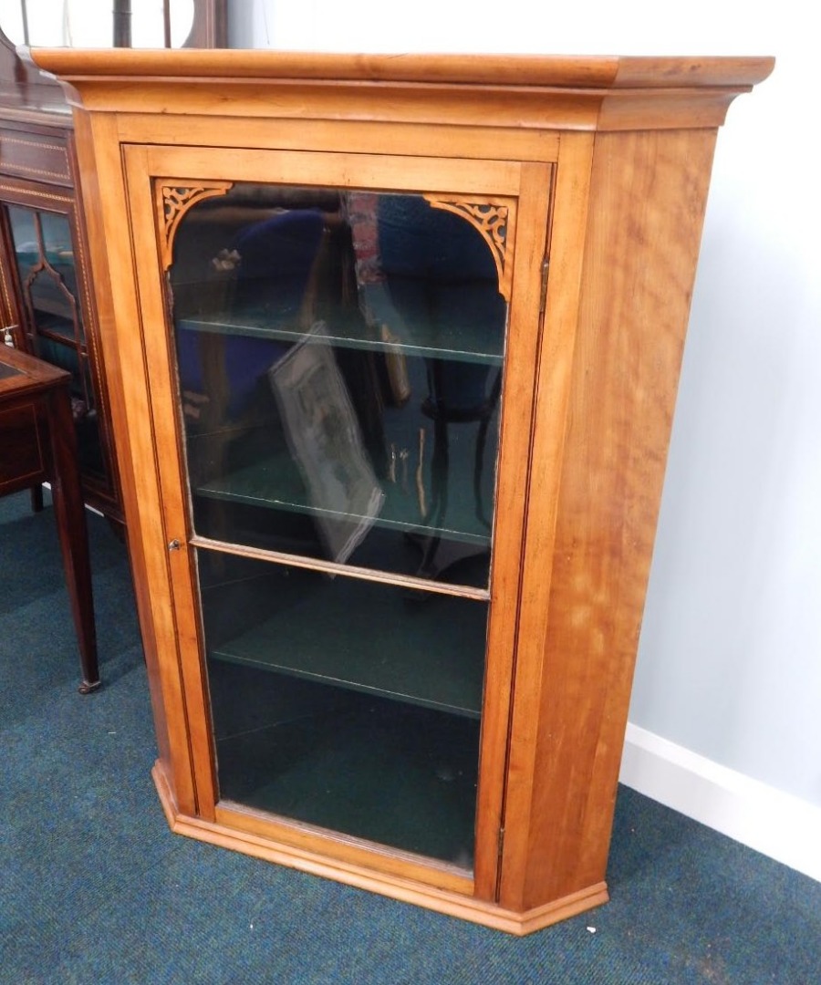 Appraisal: A Victorian satin birch hanging corner cabinet with single glazed