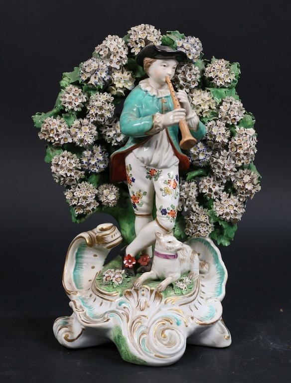 Appraisal: Chelsea porcelain figure of a musician With bocage background Red