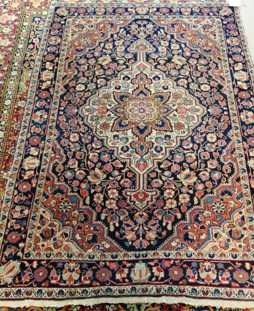 Appraisal: A Sarough rug Persian the black field with an ivory