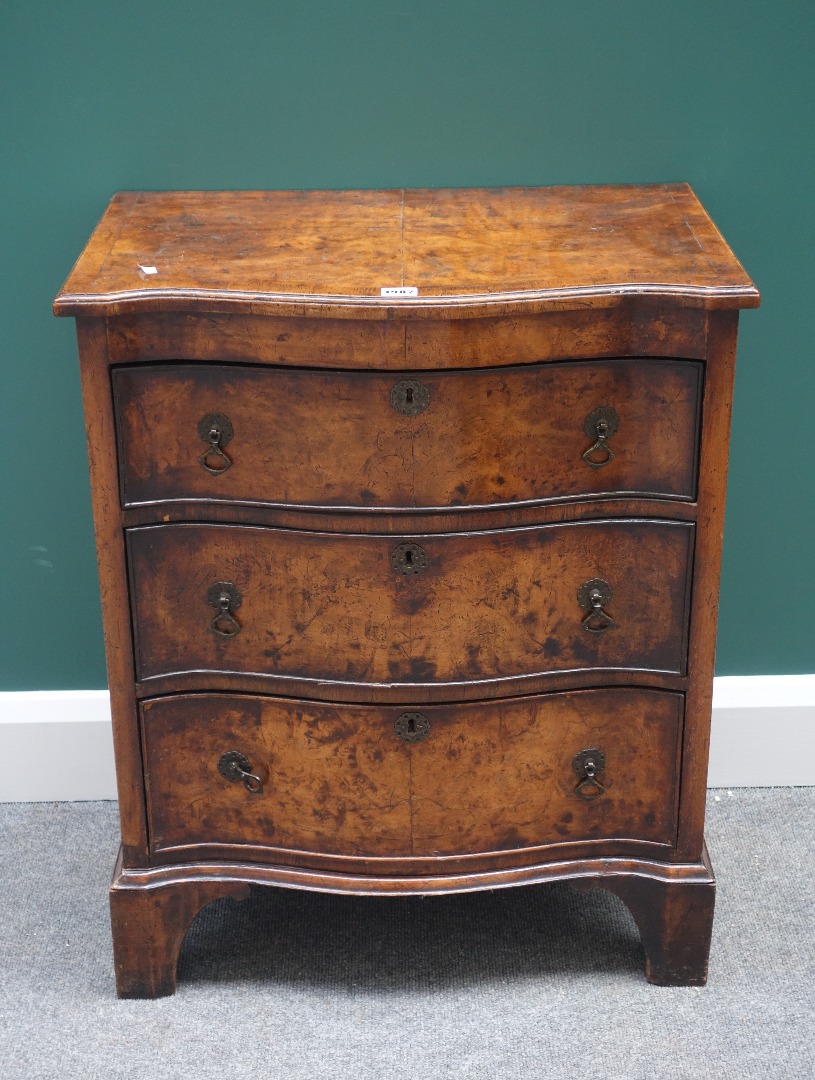 Appraisal: An th century stye figured walnut small serpentine chest of