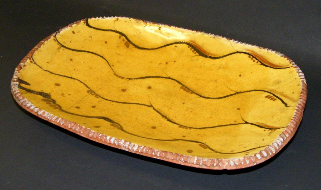 Appraisal: Slipware pottery oblong dish with wavy designs impressed seal mark