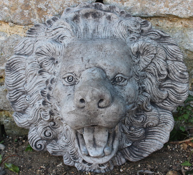 Appraisal: A RECONSTITUTED STONE LION MASK WALL FOUNTAIN WITH FLARING MANE