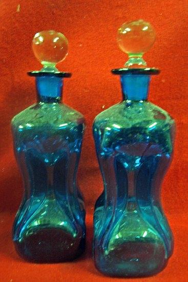 Appraisal: A pair of hourglass shaped decanters blue tinted with clear