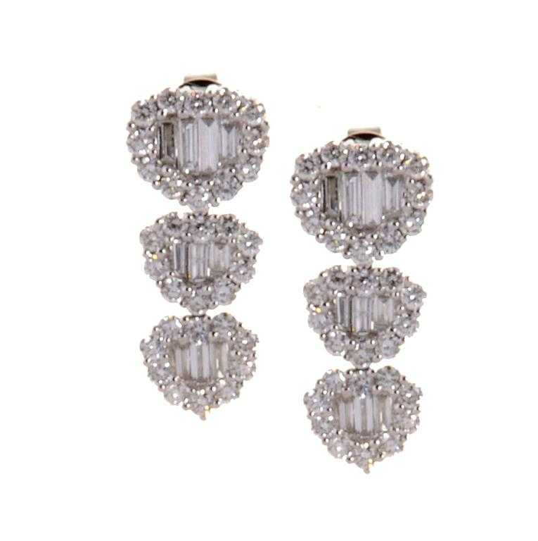 Appraisal: A PAIR OF DIAMOND EARRINGS of three descending clusters of