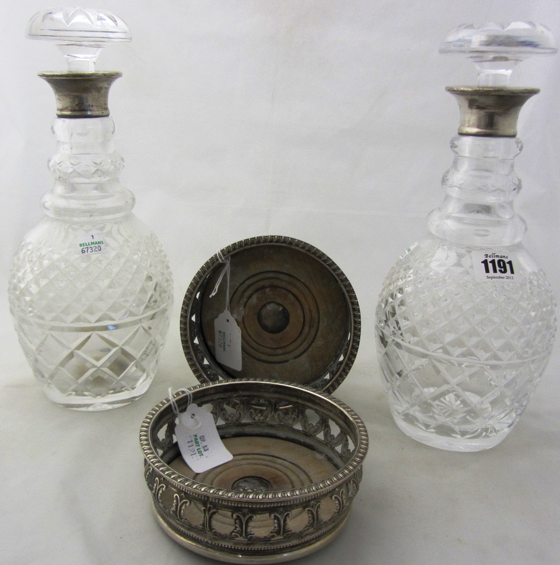 Appraisal: A pair of silver mounted faceted glass decanters London and