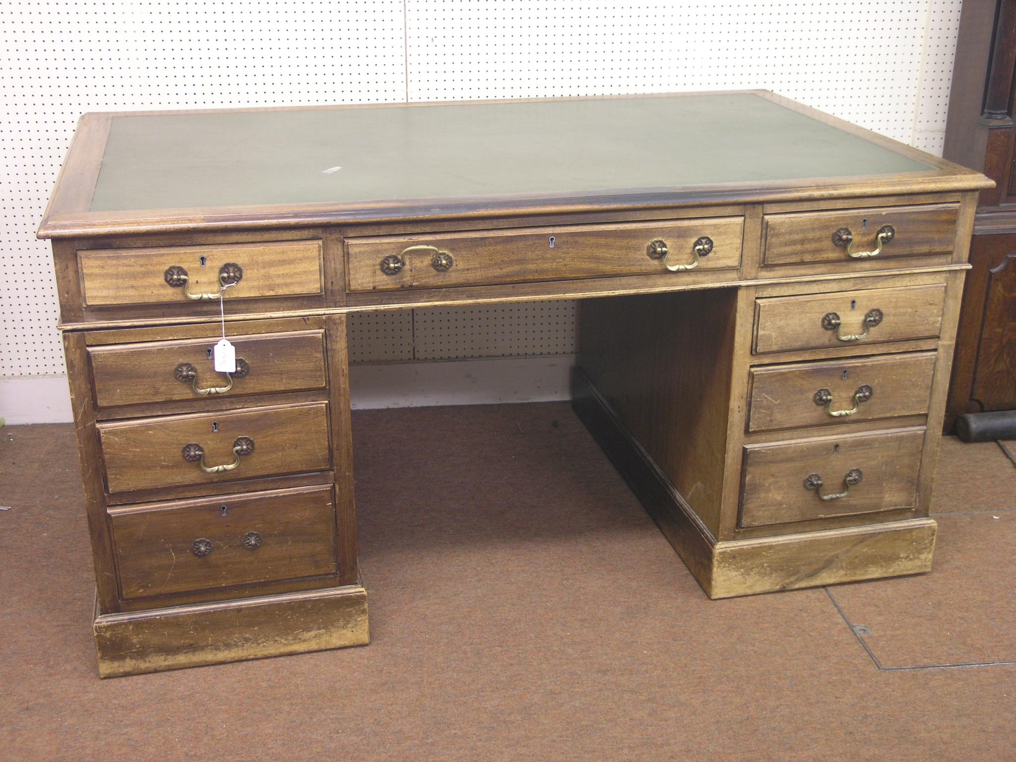 Appraisal: A Georgian-style mahogany pedestal desk inset vinyl top above three