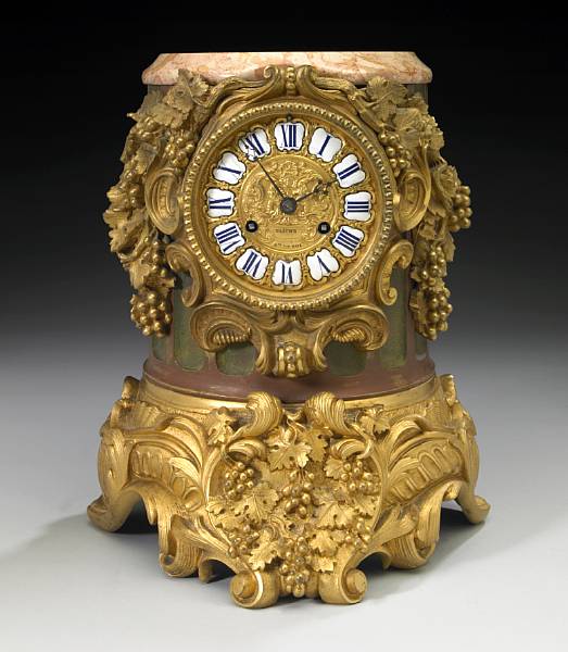 Appraisal: A Louis XVI style gilt and patinated bronze mantel clock