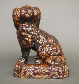 Appraisal: Rockingham dog A th century Rockingham dog Classical seated Spaniel