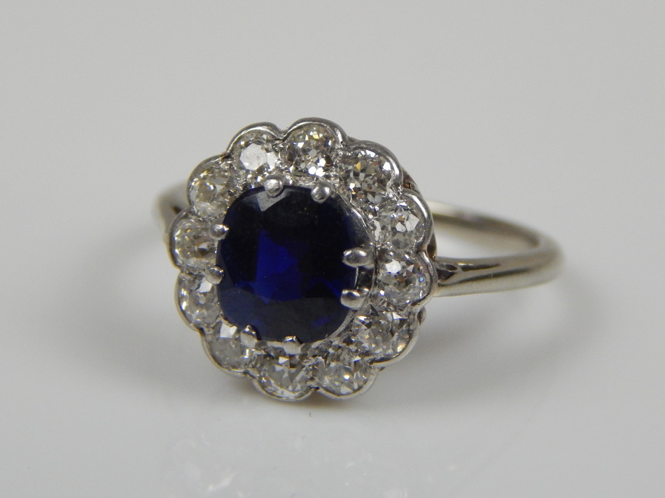 Appraisal: A sapphire and diamond floral cluster ring the central dark