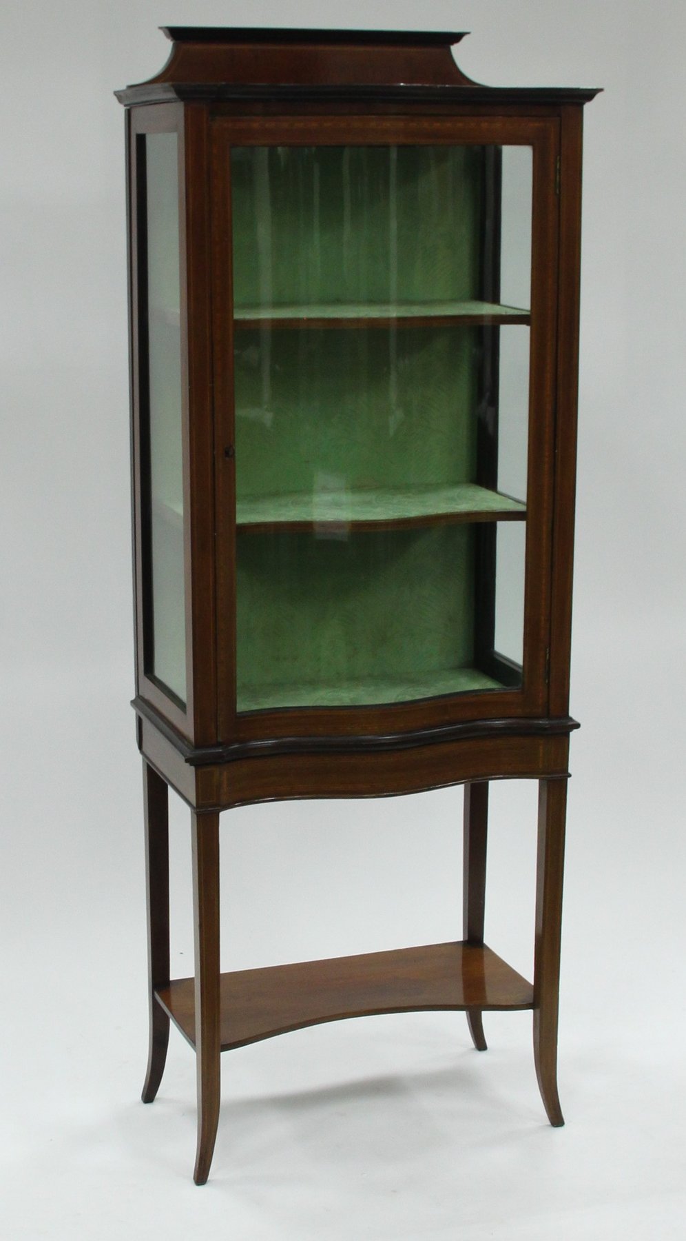 Appraisal: An Edwardian mahogany display cabinet with serpentine glass panelled door