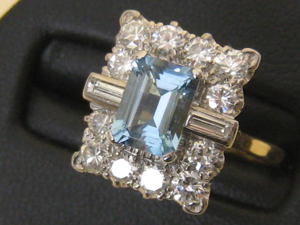 Appraisal: An Aquamarine and Diamond Cluster Ring the central step-cut aquamarine