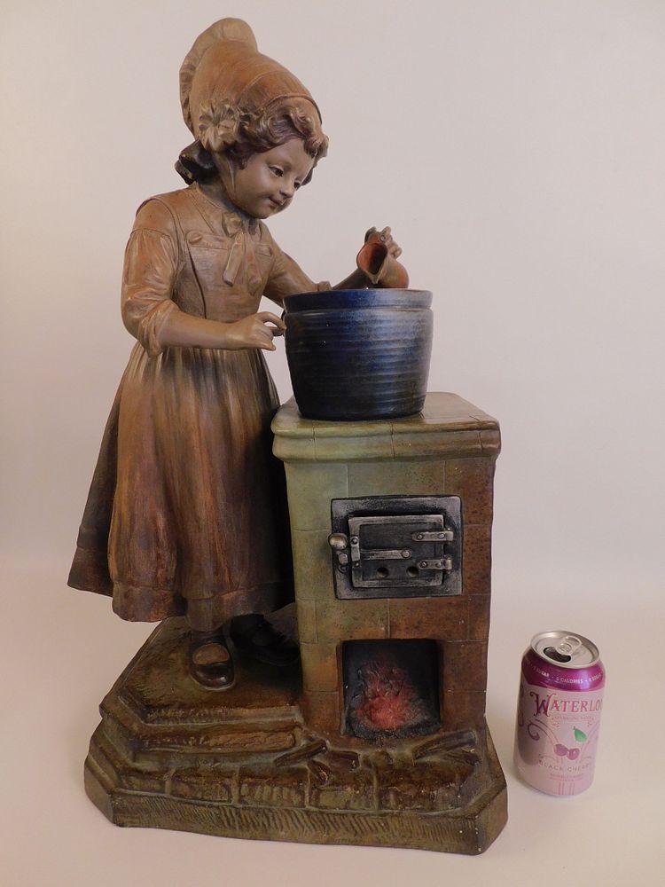 Appraisal: LARGE CERAMIC SCULPTURE - GIRL AT STOVE Circa ceramic painted