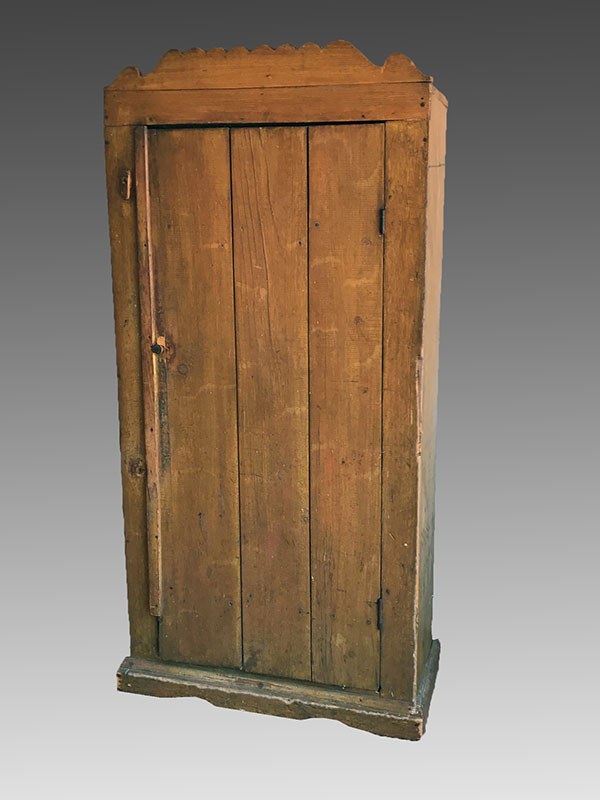 Appraisal: PRIMITIVE SINGLE DOOR COUNTRY CUPBOARD Shaped crest over single blind