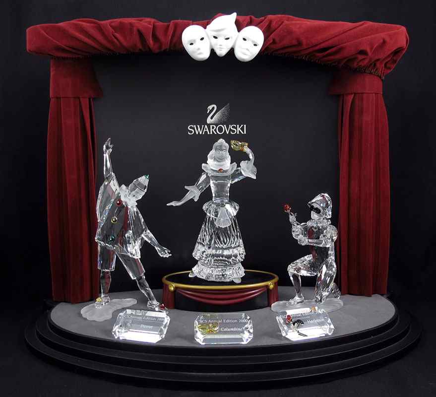 Appraisal: SWAROVSKI CRYSTAL FIGURINES THE MASQUERADE TRILOGY with Stage Display smaller