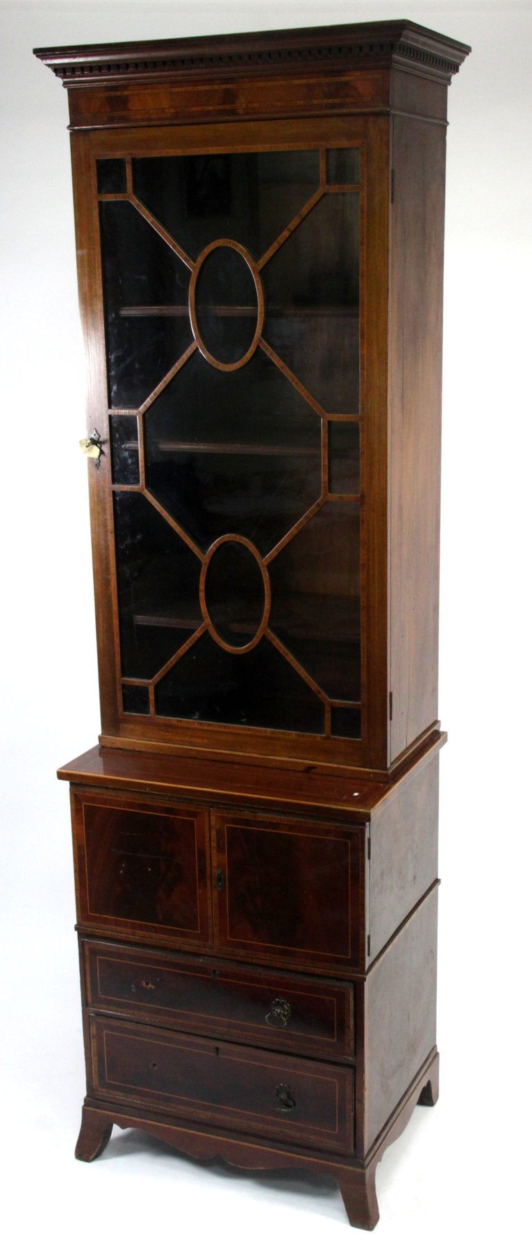 Appraisal: An Edwardian mahogany bookcase of narrow proportions the dentil cornice