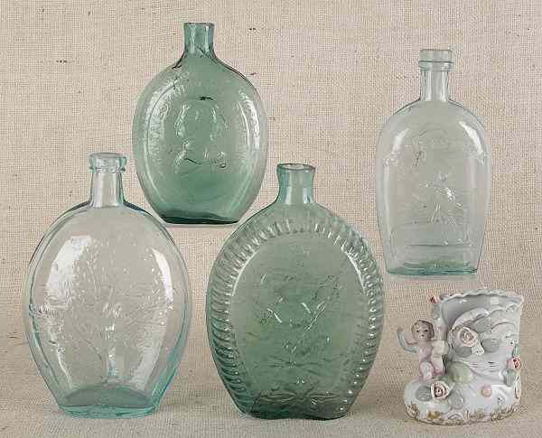 Appraisal: Four glass flasks together with a porcelain match holder