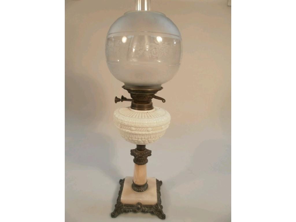 Appraisal: A Victorian oil lamp with moulded opaque reservoir on alabaster