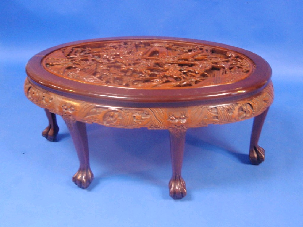 Appraisal: A deep carved camphor wood coffee table with battle scenes