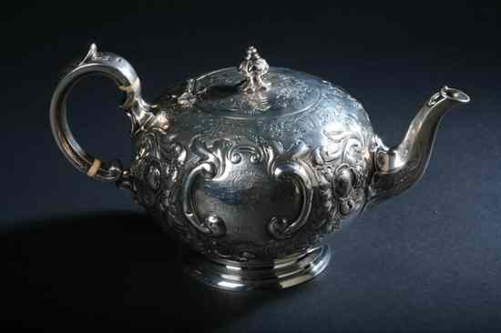 Appraisal: VICTORIAN SILVER TEAPOT Martin Hall Co Sheffield Bulbous with repouss