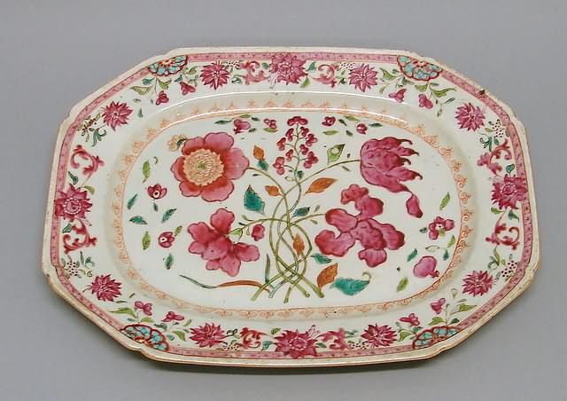 Appraisal: Oval form with canted corners bold floral sprays conforming border