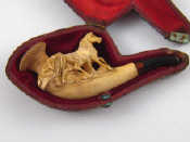 Appraisal: A carved meerschaum pipe with amber mouthpiece approx cm long