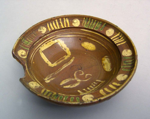 Appraisal: Redware barber's bowl late th c with elaborate slip decoration