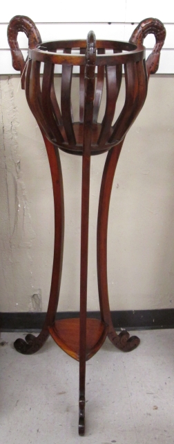 Appraisal: REGENCY STYLE MAHOGANY JARDINIERE STAND featuring slat-side jardiniere basket suspended