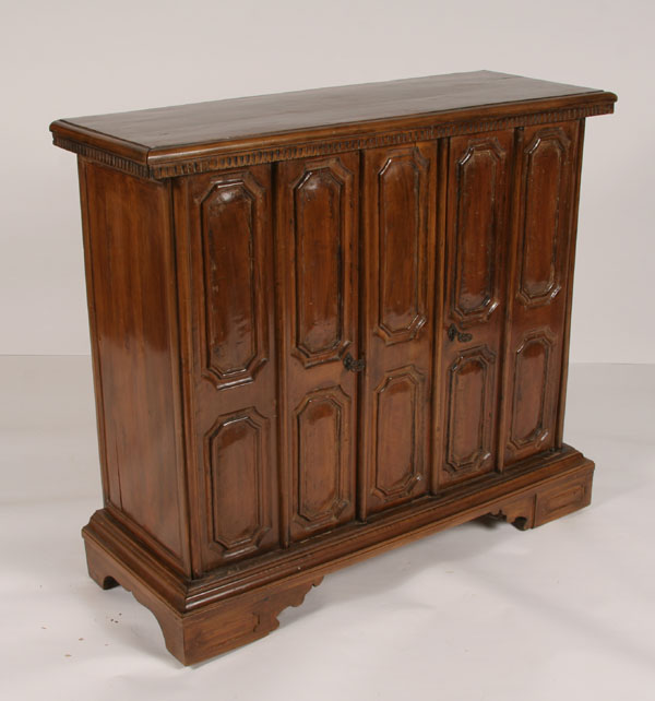 Appraisal: Paneled wood two door cabinet bracket feet carved front and