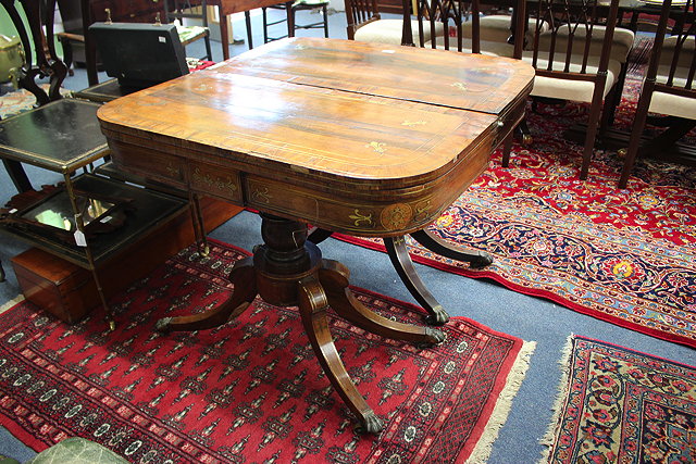 Appraisal: A PAIR OF REGENCY ROSEWOOD AND BRASS INLAID PEDESTAL FOLDOVER