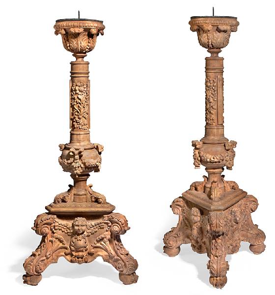 Appraisal: A pair of Baroque style carved wood torch re stands