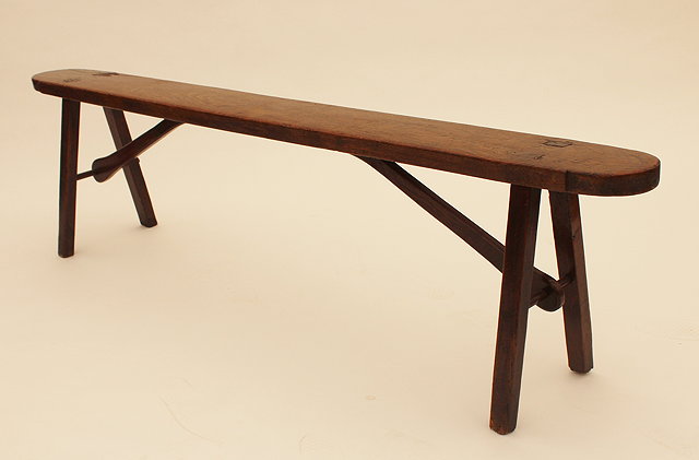 Appraisal: AN ANTIQUE ELM WOOD NARROW SCHOOL BENCH with four pegged