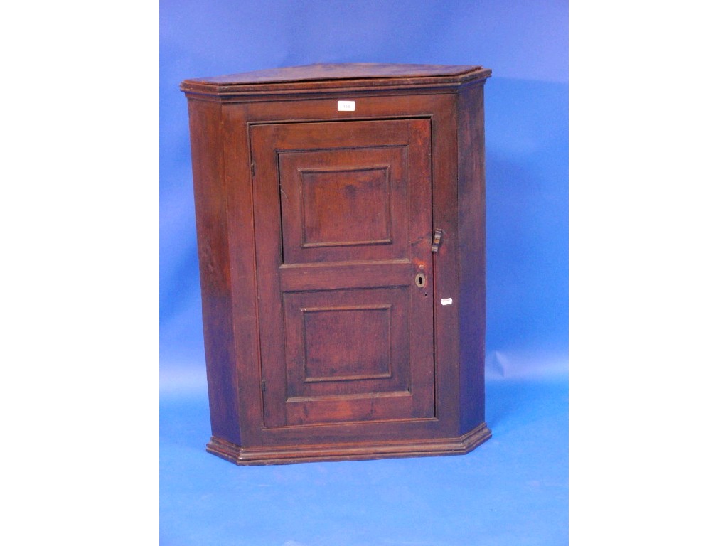 Appraisal: A Georgian oak hanging corner cupboard with double panel door