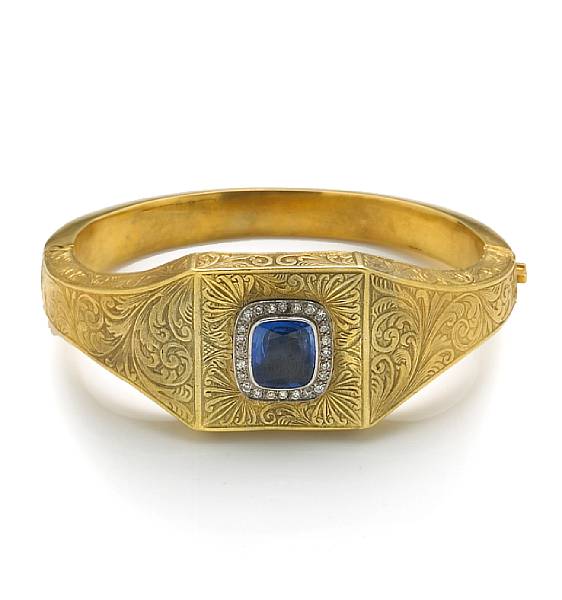 Appraisal: A sapphire diamond and fourteen karat gold bangle bracelet centering