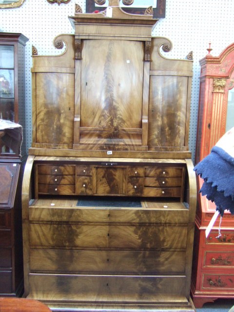 Appraisal: A th century Biedermeier mahogany bureau cabinet the shaped crest