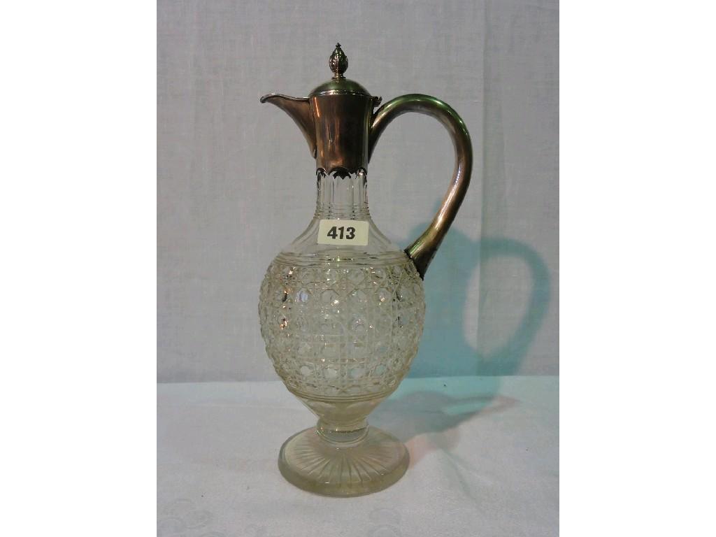 Appraisal: A glass claret jug with silver mounted lid and handle