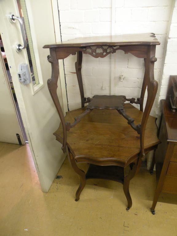 Appraisal: An Edwardian mahogany two-tier occasional table on shaped supports and