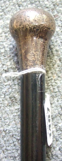 Appraisal: An ebonised walking cane with silver pommel mount and a