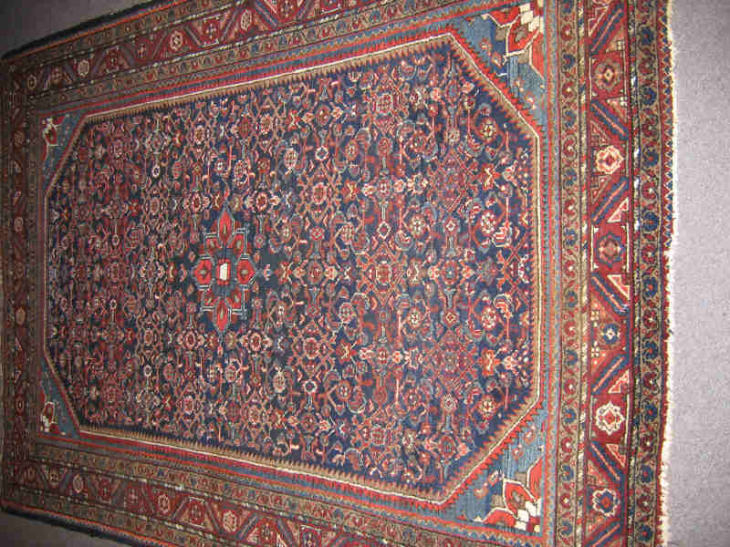 Appraisal: HAMADAN THROW RUG The indigo herati field with central floral