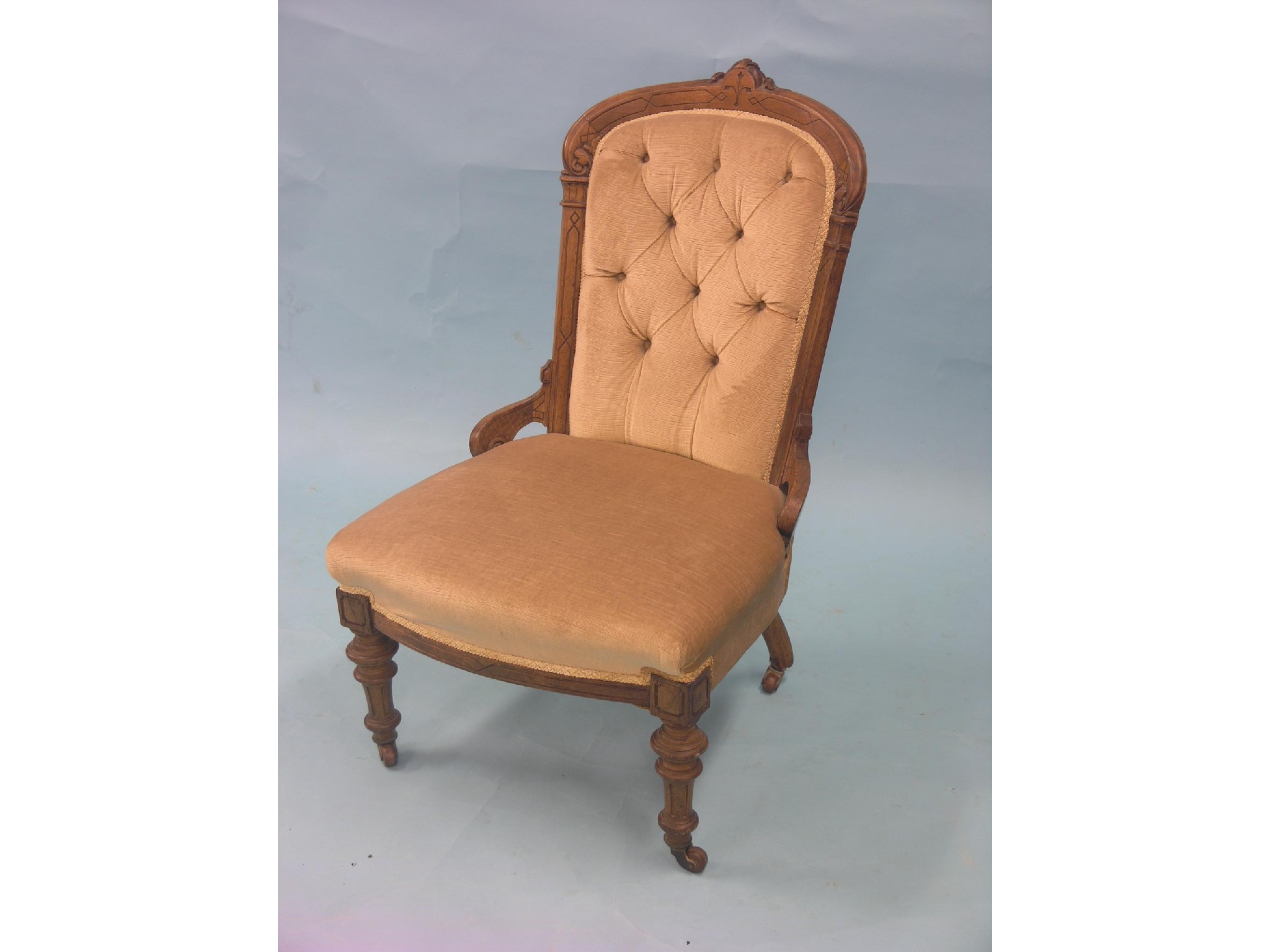 Appraisal: A Victorian walnut nursing chair upholstered in a buttoned pale