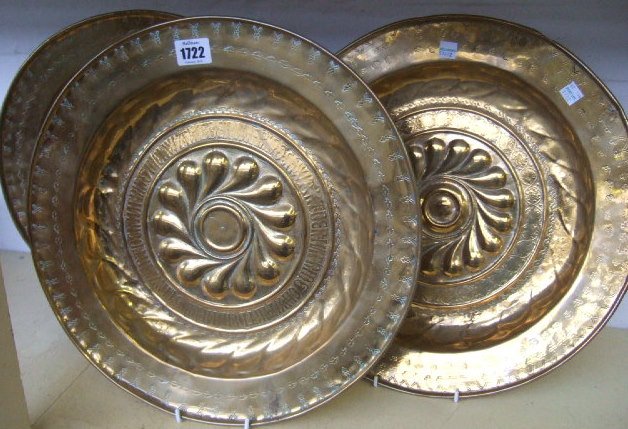 Appraisal: A collection of three similar brass alms dishes with swirling