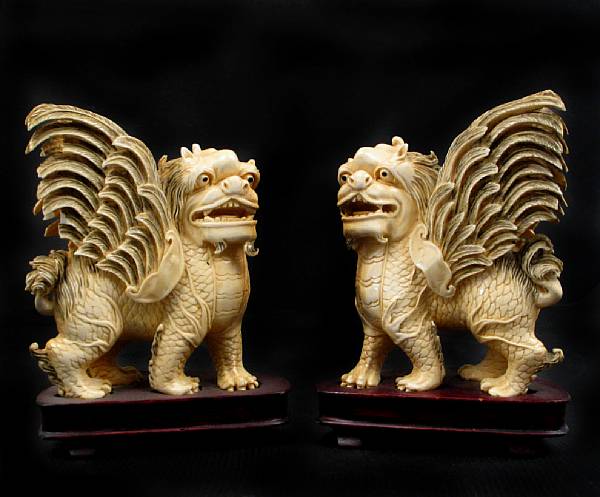 Appraisal: A pair of Chinese ivory winged lions height in width