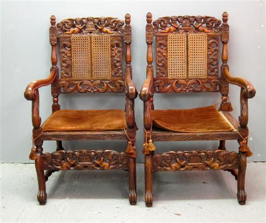 Appraisal: Pair of th century style carved oak armchairs profusely carved